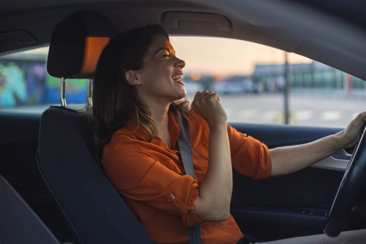 Woman singing in the car while driving