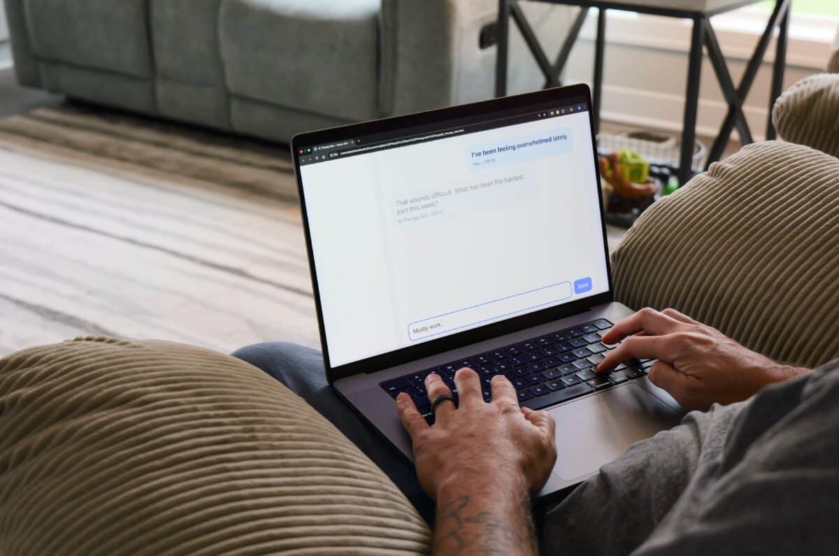 Middle Aged Man in Tan Recliner Texting AI Chatbot